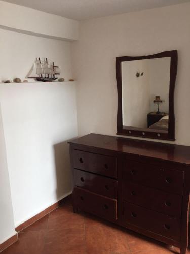 a bedroom with a dresser and a mirror at Nizar Surf Morocco in Taghazout