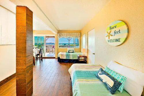 a hotel room with a bed and a view of the ocean at OB Pier 1 in San Diego