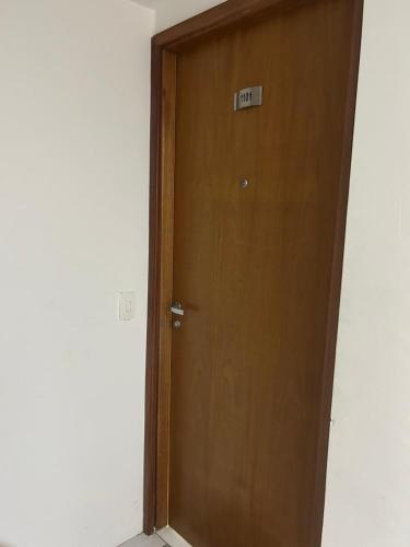 a wooden door with a sign that reads exit at Flat Boa Viagem -500 m praia - Golden Style in Recife