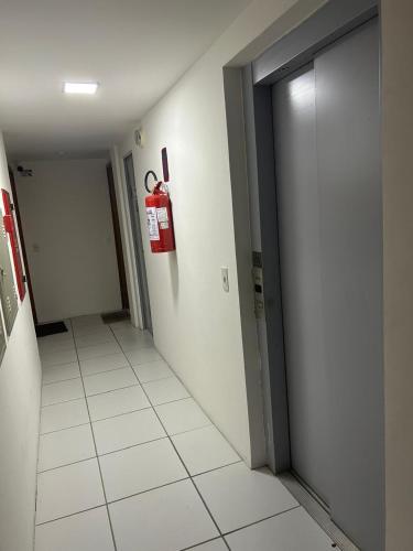 a hallway with a fire hydrant on the wall at Flat Boa Viagem -500 m praia - Golden Style in Recife