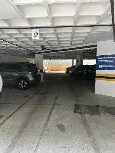 a parking garage with a car parked in it at Flat Boa Viagem -500 m praia - Golden Style in Recife
