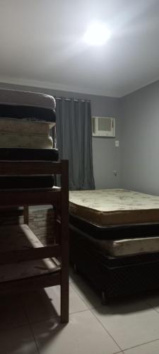 Ένα ή περισσότερα κρεβάτια σε δωμάτιο στο Casa de 2 Quartos em Cabo Frio