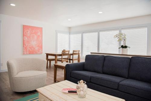 a living room with a couch and a table at Seaside Retreat Hot Tub Steps to Beach Slps 6 in Seaside