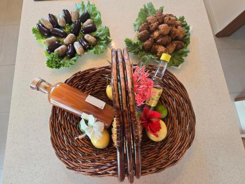 a basket of vegetables and chopsticks on a table at Villa Manakit in Petit-Bourg