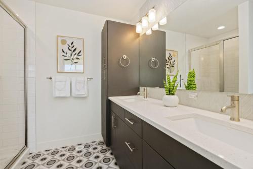 a bathroom with a sink and a mirror and a shower at Mountain View Home with King Beds and Rooftop Deck in Fort Collins