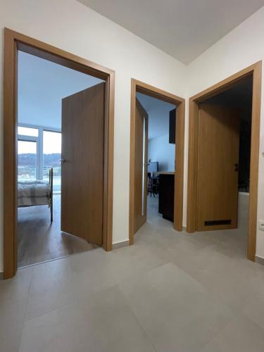 a room with two doors and a bedroom with a view at Apartmán Bellevue in Boskovice