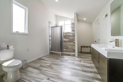 a bathroom with a toilet sink and a shower at Deck with Lake Barkley Views Spacious Family Home! in Eddyville