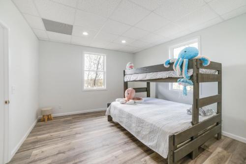 a bedroom with a bunk bed with a baby on it at Deck with Lake Barkley Views Spacious Family Home! in Eddyville