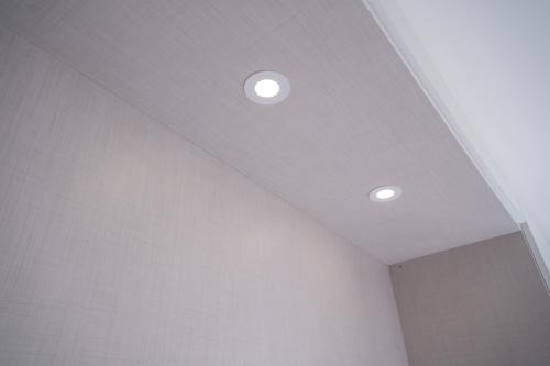 a ceiling with two lights in a room at ApArtStudio in Oliveira de Frades