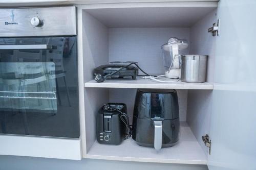 a kitchen with a coffee maker and a blender at ApArtStudio in Oliveira de Frades