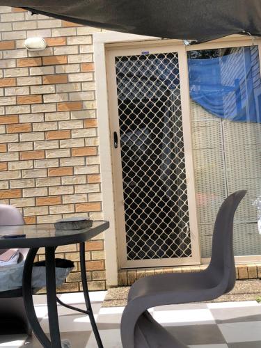 a grill on a window with a table and a table at Private room in Gold Coast