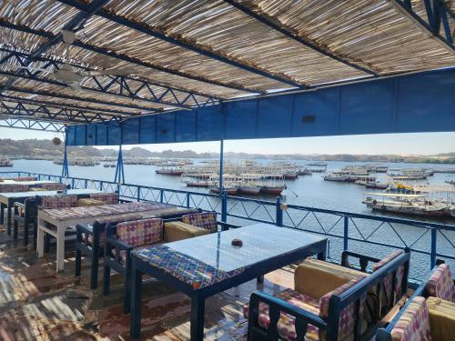 a view of a marina from a restaurant with tables and chairs at Endo Mando in Shellal