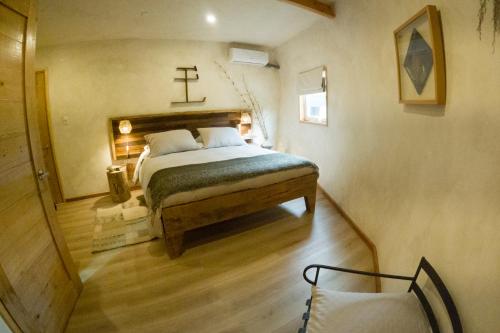 - une chambre dotée d'un lit avec une croix sur le mur dans l'établissement Ascenso Kimün, à Pucón