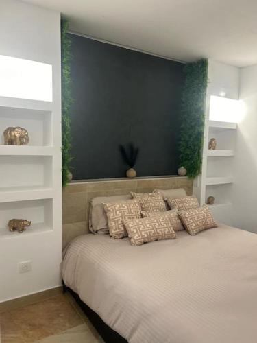 AvolsheimにあるMagnifique gîte avec jacuzzi et sauna privatifsの枕が置かれたベッドのある寝室