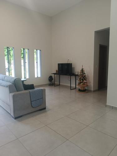 a living room with a couch and a christmas tree at Estância da Mata, Brasil in Lapinha
