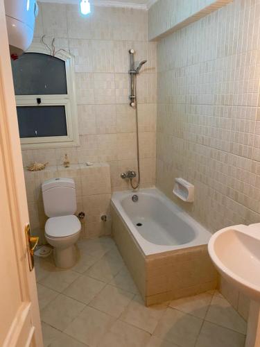 a bathroom with a tub and a toilet and a sink at Villa Sharm El-Sheikh in Sharm El Sheikh