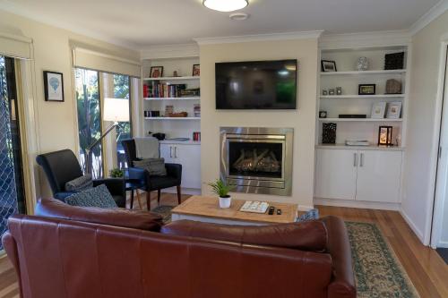 a living room with a couch and a fireplace at Emerald Ridge in Emerald