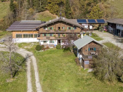 an aerial view of a house with a dirt road in front at Grabnerhof in Brixen im Thale