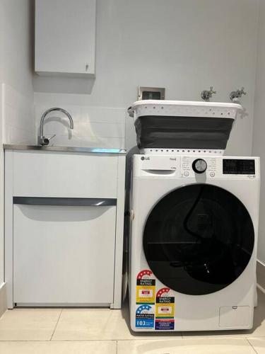 a kitchen with a microwave and a sink at Modern Loft Retreat in Barton Canberra ACT near Parliament House in Barton