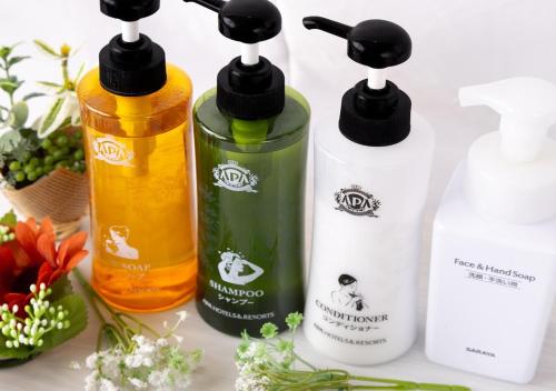 a group of three bottles of detergents on a counter at APA Hotel Kobe Sannomiya in Kobe