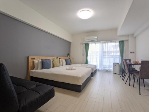 a hotel room with a bed and a couch at ESLEAD HOTEL Namba South Ⅱ in Osaka