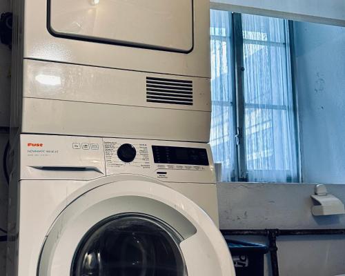 a washer and dryer in a room at Cozy Little Apartment in Dübendorf
