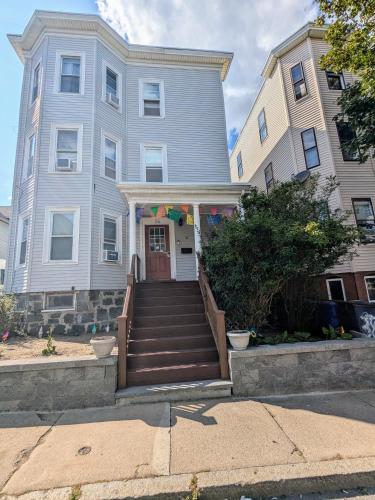 a house with a staircase leading to the front door at Boston Homestel in Boston