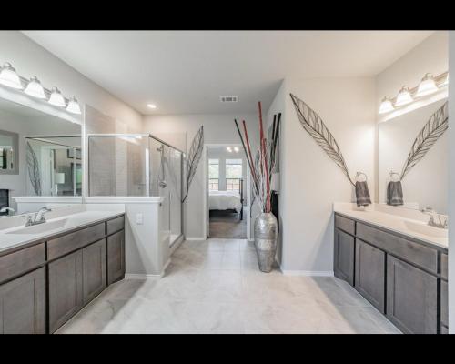 a bathroom with two sinks and a large mirror at The in Crowley