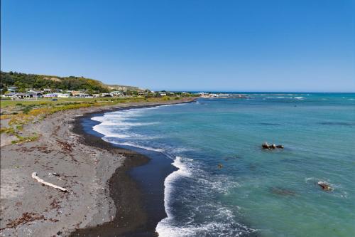 an aerial view of the shore of a beach at A Classic Kiwi Bach in South Bay in Kaikoura