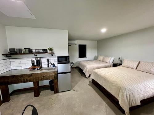 a room with two beds and a desk in it at The Rocky Retreat in Cookson
