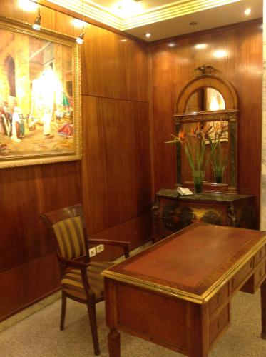 a dining room with a table and a chair at El Hana International in Tunis