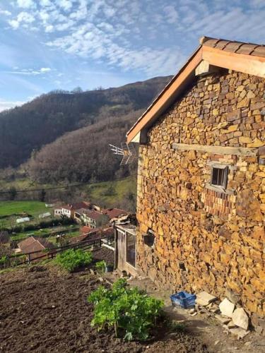 a stone building sitting on top of a hill at El Balcón de Urbiés in Mieres