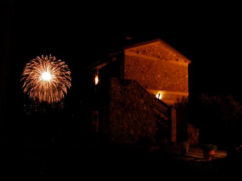a firework in the dark with a building in the background at Azienda Agricola Il Querceto in Marsico Vetere