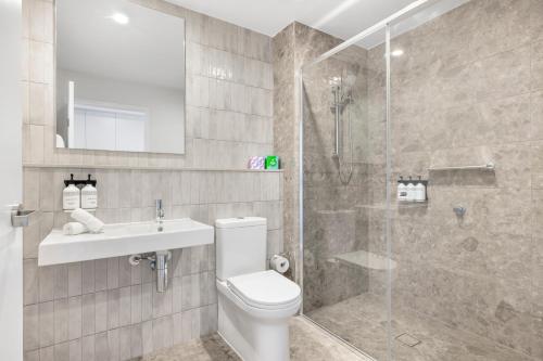 a bathroom with a toilet and a sink and a shower at Rambla at Story House in Brisbane