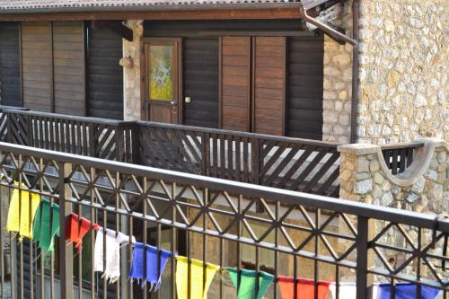 a fence with prayer flags in front of a house at Azienda Agricola Il Querceto in Marsico Vetere
