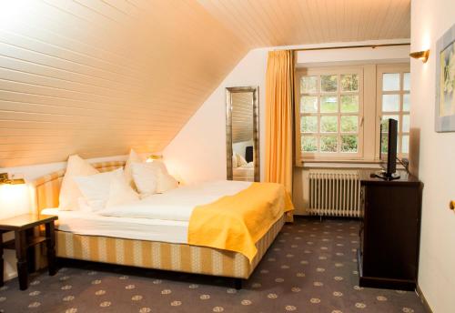 a hotel room with a bed and a window at Hotel Niedersächsischer Hof in Bad Bentheim