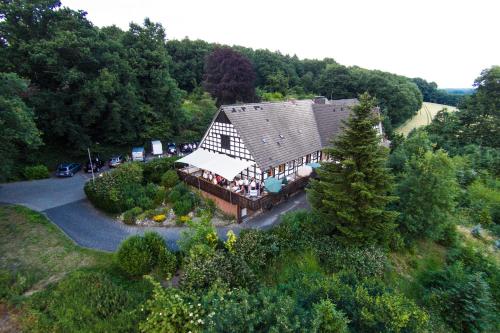 an aerial view of a large house in the forest at Hotel Niedersächsischer Hof in Bad Bentheim