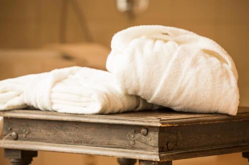 a pile of towels sitting on a table at Hotel Niedersächsischer Hof in Bad Bentheim