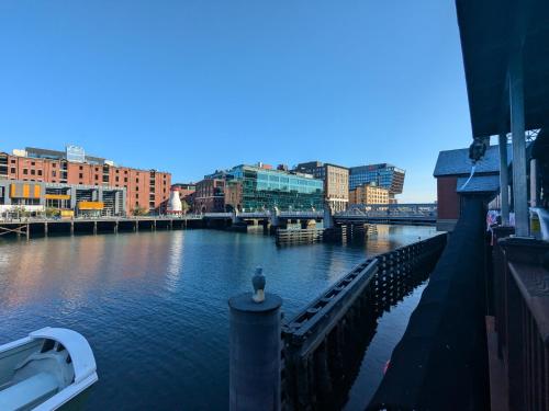 a boat is docked on a river in a city at Boston Homestel in Boston