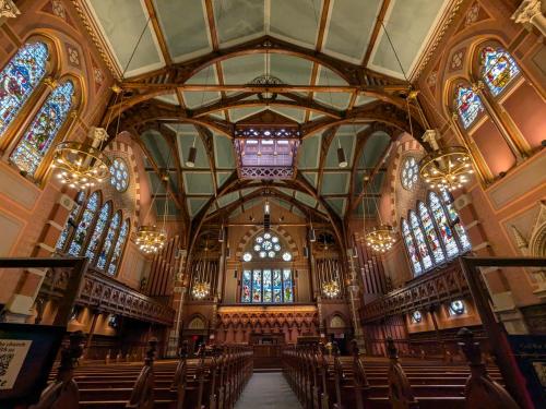 a large church with chairs and stained glass windows at Boston Homestel in Boston