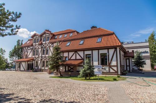 a large building with a red roof at Fregata in Ełk