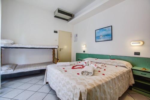 a bedroom with a bed with red roses on it at Hotel San Paolo in Rimini