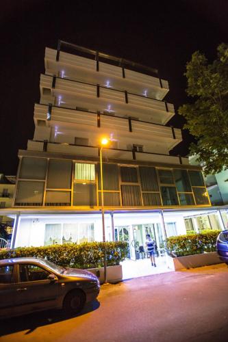 a car parked in front of a building at night at Hotel San Paolo in Rimini