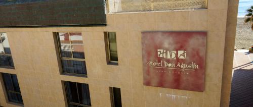 a building with a sign on the side of it at Don Agustin in San Luis de Sabinillas