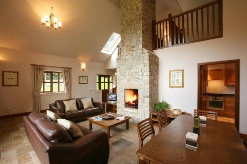 a living room with a couch and a fireplace at Mount Falcon Estate in Ballina