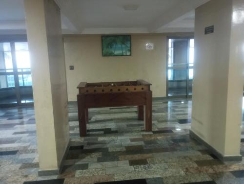 a piano in the middle of a room at Apto com Piscina - Lazer Completo-Mongaguá centro in Mongaguá