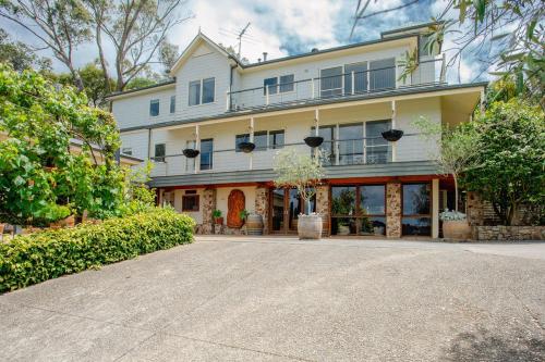 a large white house with windows and a driveway at Morning Sun Vineyard in Main Ridge
