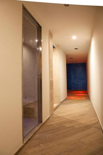 a hallway with a glass door in a building at La Vignola Country Hotel in Ceprano