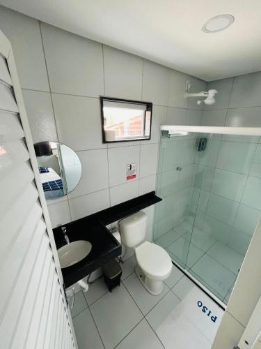 a bathroom with a toilet and a sink and a shower at Flat Rainha da Serra in Bezerros