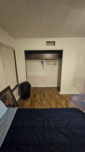 a bedroom with a garage door with a black bed at Cozy Private Room 2 with Extras in Dallas